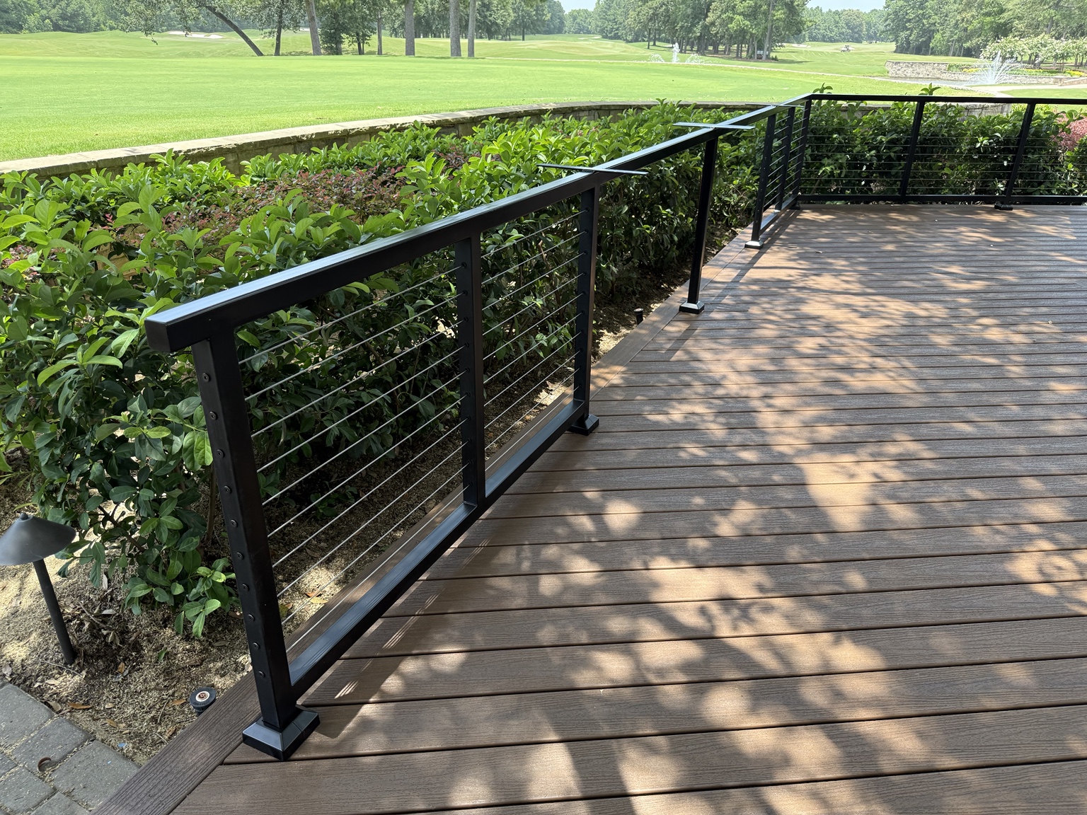 White Hog black steel cable railing installed on an elevated wood deck
