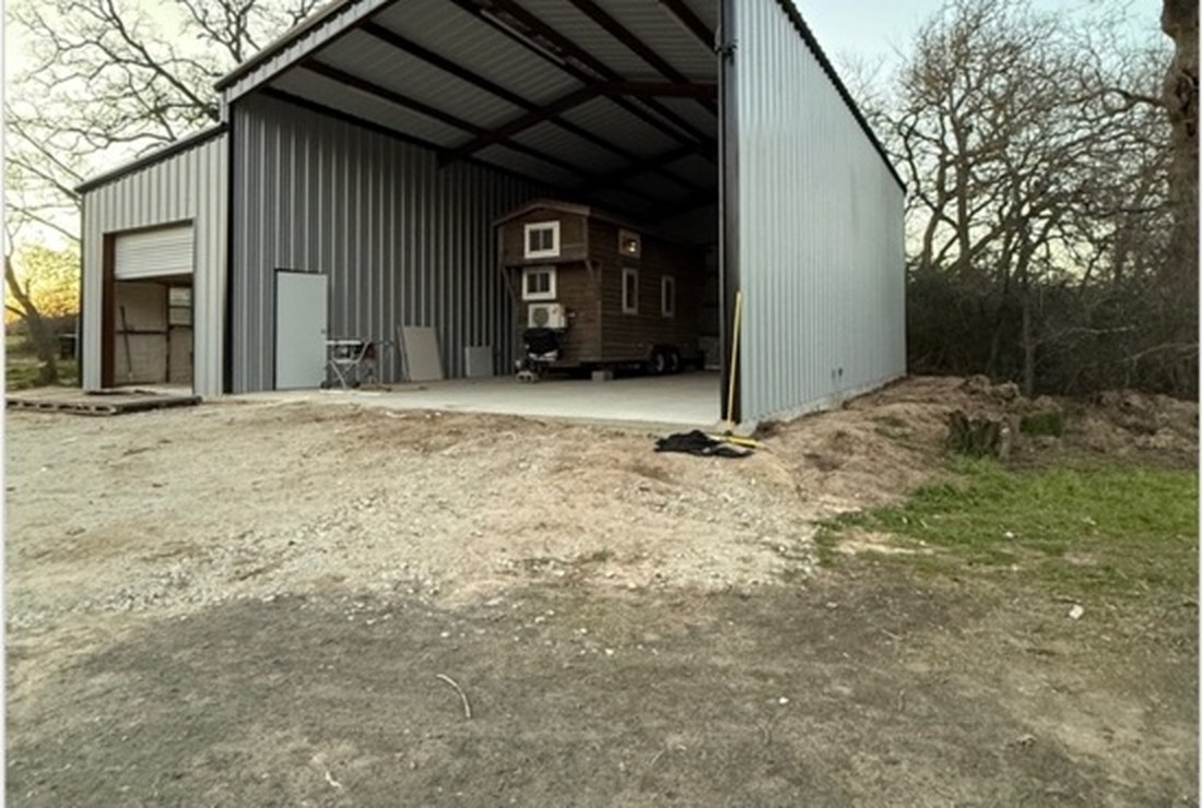 White Hog custom metal building with an equipment bay and enclosed workshop
