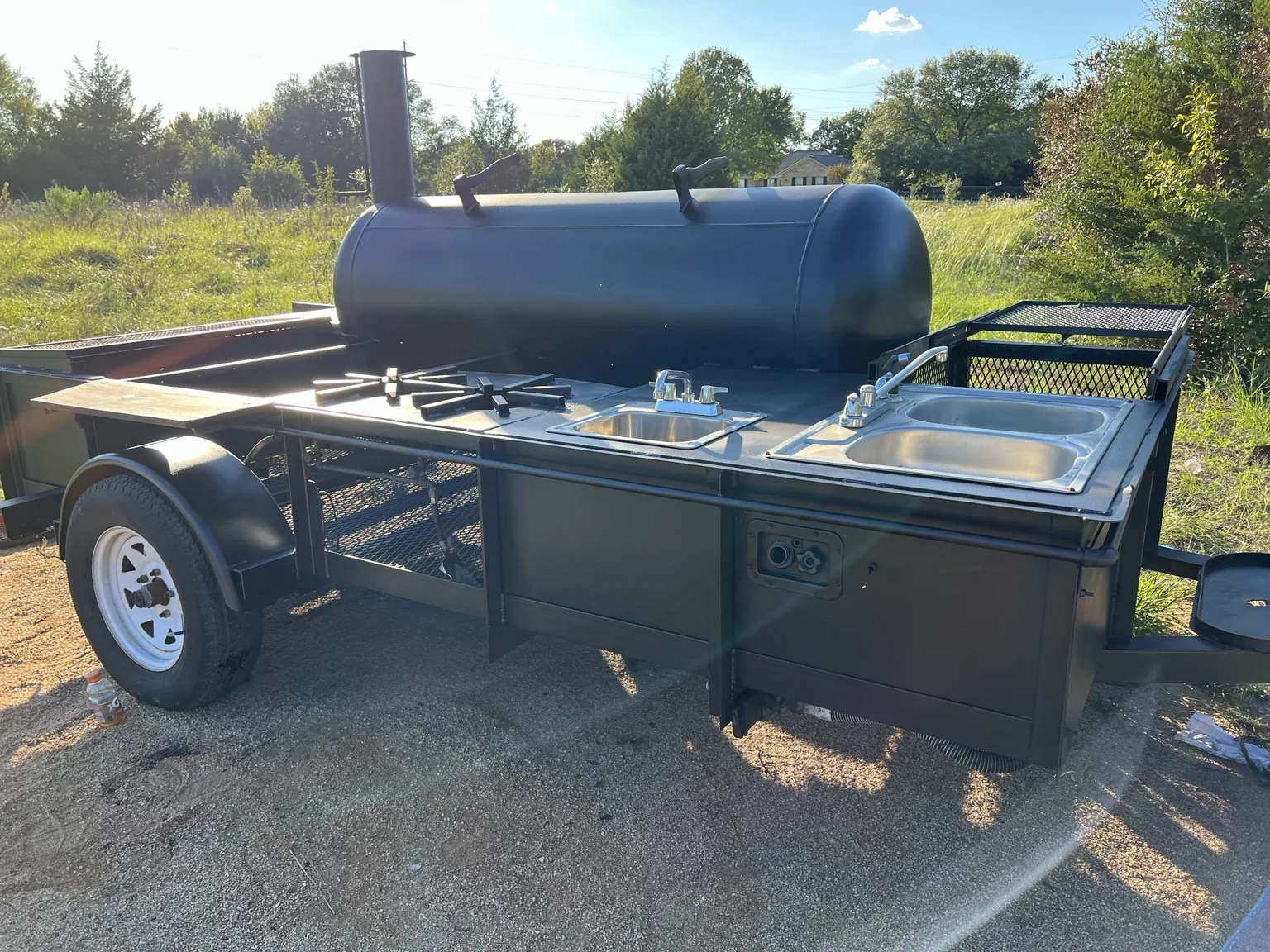 Custom fabricated smoker and outdoor cooking station mounted on a utility trailer